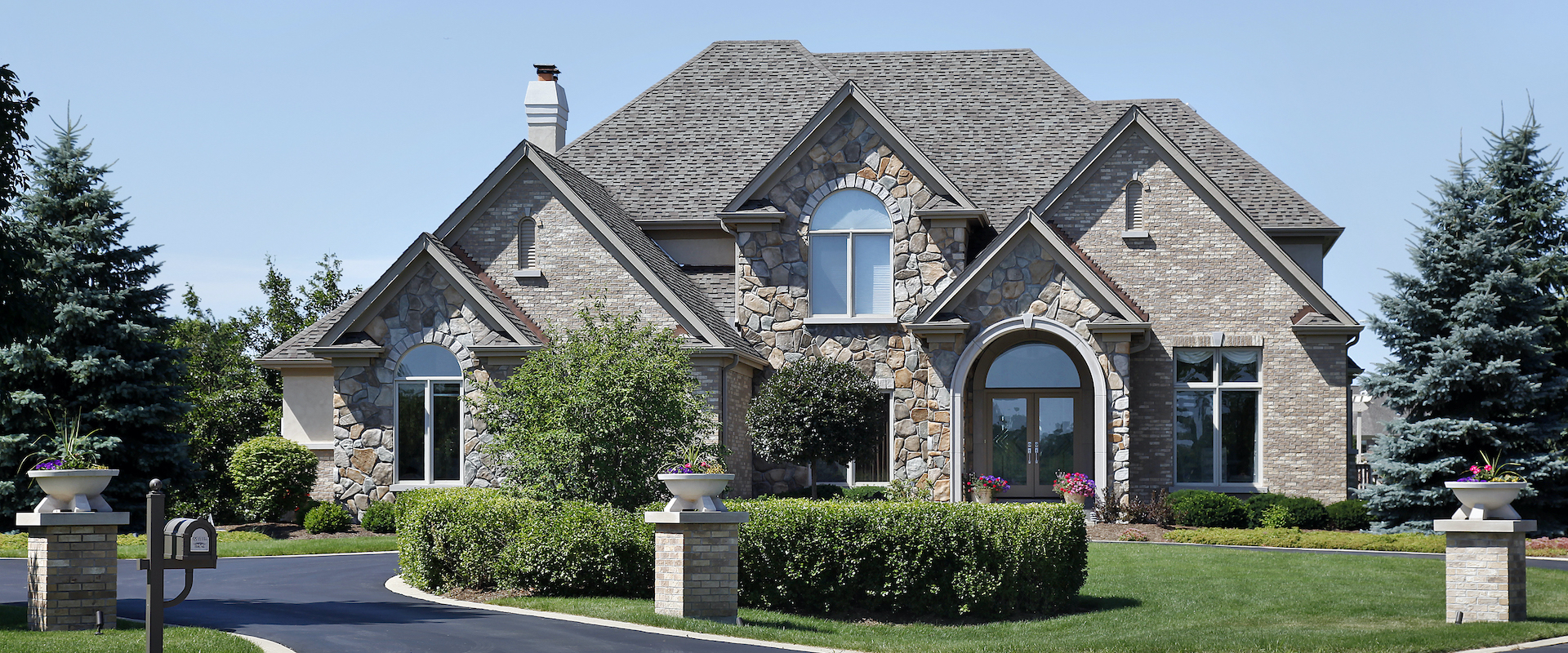 Brick and stone home with cedar roof Reeves-Construction-South-Carolina-Roofing-Gutters-Sealcosting-02